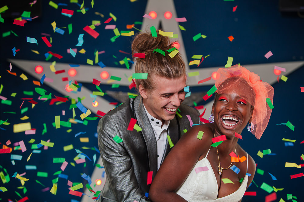 bespoke cookies, Bridal shoot, colouful wedding photographs, colour block, colour block wedding stationery, colour pop weddings, colour veils, colourful invitatations, colourful invitations, Colourful wedding, colourful wedding stationery, confetti, diversity weddings, festival invitations, fun wedding, gingerbread cake, gingerbread wedding cake, Hackney, hackney weddings, heart coookies, lanyard invitations, Love and Adventures, McFadden Millinery, mixed race couple, neon eyeshadow, neon tie, neon wedding, neon wedding stationery, Pinata, piñata, piñata cake, piñata unicorn cake, pride, pride after party, Pub wedding, quote cookies, Rainbow wedding, rave wedding, smash the cake, stereotypes, sweet filled cake, sweets, un-traditional wedding, unicorn, unicorn cake, urban wedding, vibrant wedding inspiration, wedding stationery